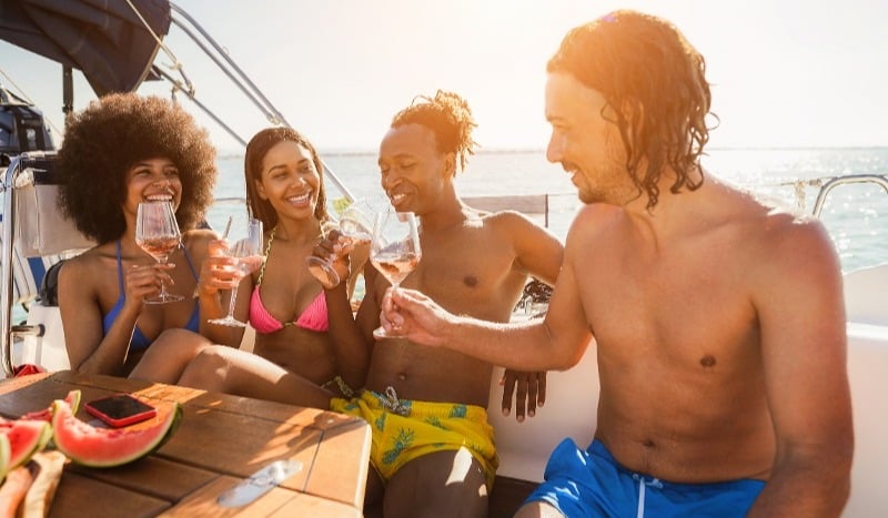 happy-multiracial-friends-having-fun-drinking-cham-2023-11-27-04-57-41-utc-1